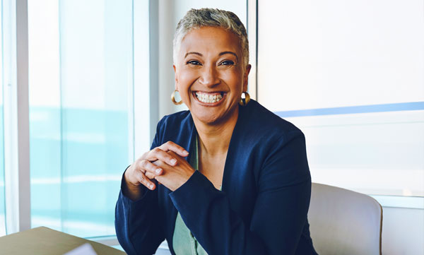 AgeSMART client services team member smiling, representing compassionate coordination and non-medical in-home senior support for aging in place