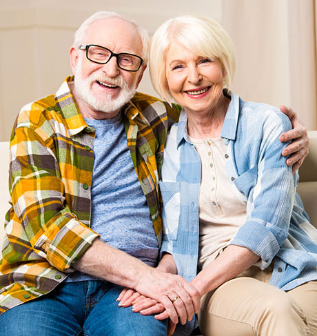 Smiling senior couple representing trusted senior care support and answered questions for families