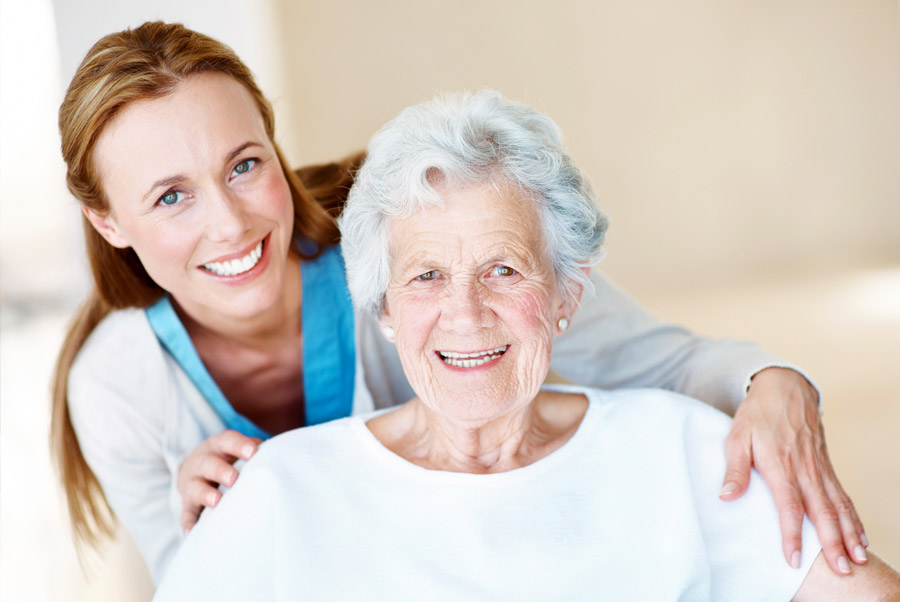 Caregiver supporting older adult at home during a calm and reassuring in-home care visit