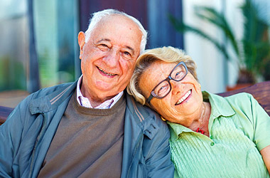Smiling AgeSMART lifestyle concierge team member at desk representing personalized senior support